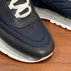 Givenchy navy sneaker with black trim, lace-up opening, and clear sole