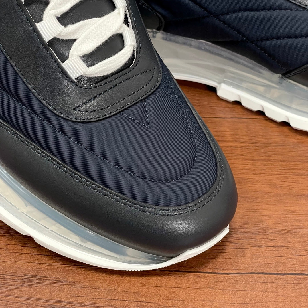 Givenchy navy sneaker with black trim, lace-up opening, and clear sole