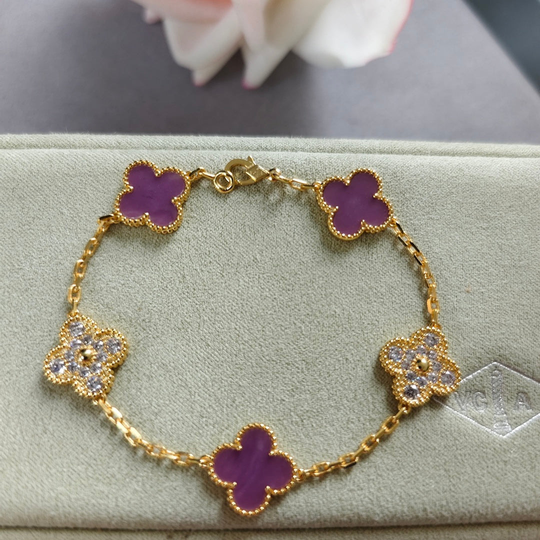Gold-tone clover enamel bracelet with purple quatrefoil charms and sparkling accents