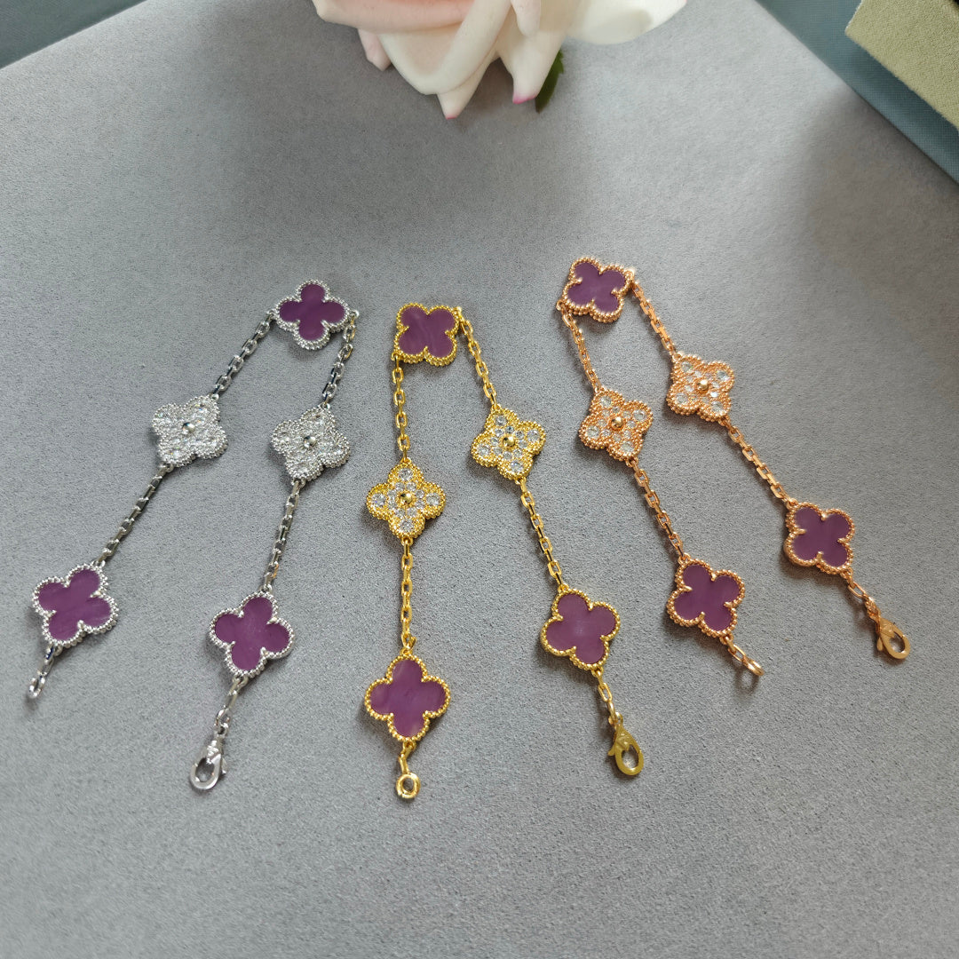 Set of clover charm bracelets with purple enamel, in silver, gold, and rose gold tones