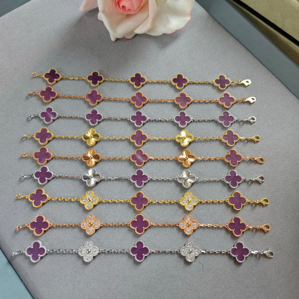 Assorted clover charm bracelets with purple enamel quattrofoil flowers in mixed metal tones