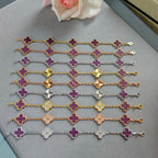 Assorted clover charm bracelets with purple enamel quattrofoil flowers in mixed metal tones