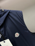 Navy hooded Moncler vest with round logo patch on chest