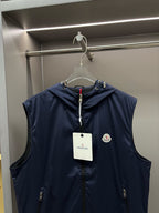 Navy hooded sleeveless vest with zip-front, logo patch, and drawcord