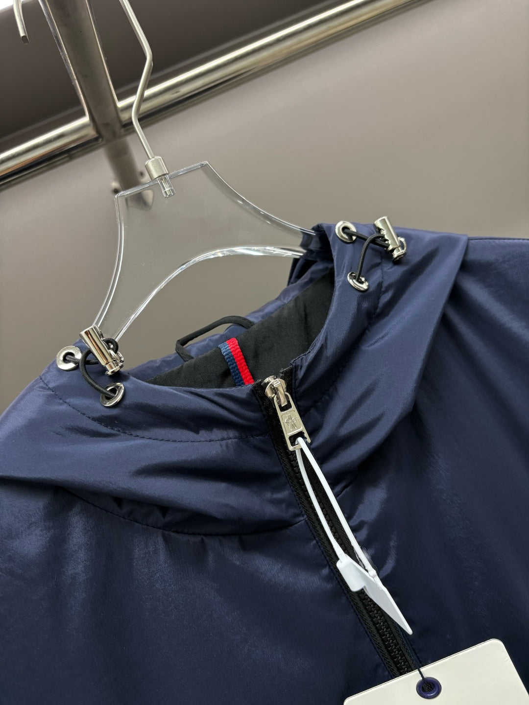 Navy hooded vest fabric with front zipper and metal pull tabs