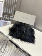 Black fuzzy slide sandal with padded strap and 'BAL' logo patch