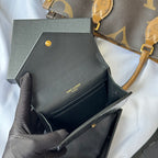 Small bag front view with black leather finish, gold snap button and SAINT LAURENT text
