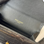 Small bag close-up of SAINT LAURENT Paris engraved logo and stitched edge seam