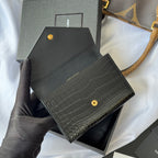 Small bag with croc-embossed black front, gold snap button and small SAINT LAURENT text