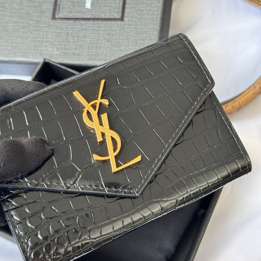 Small bag close-up: black croc-embossed flap with gold YSL logo detail