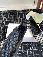 Check-print slip-on flats with black quilted toe and blue logo detail on side