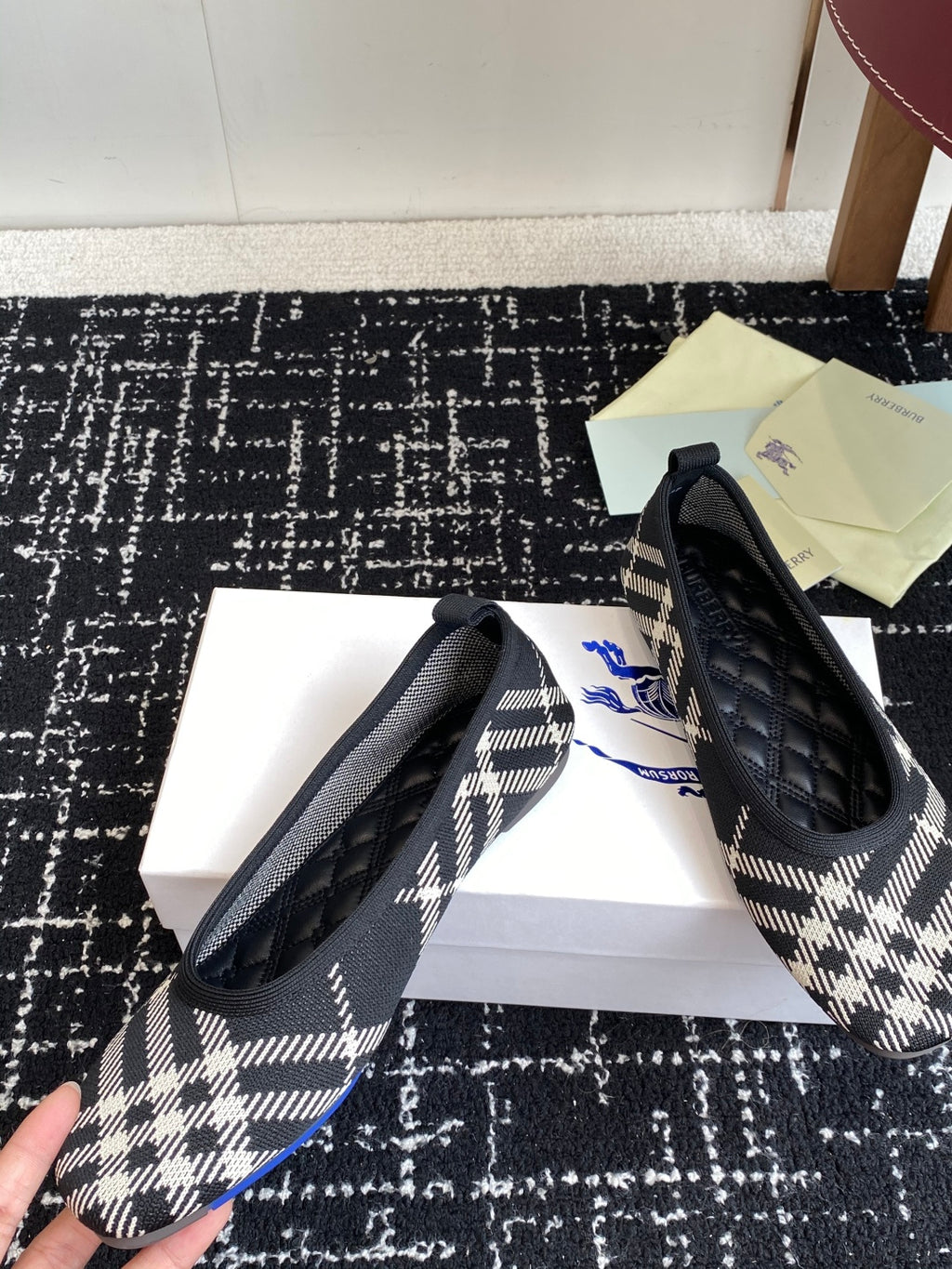 Check-print slip-on flats with black quilted uppers and blue logo embroidery