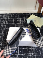 Check-print slip-on flats with black quilted uppers and blue logo embroidery