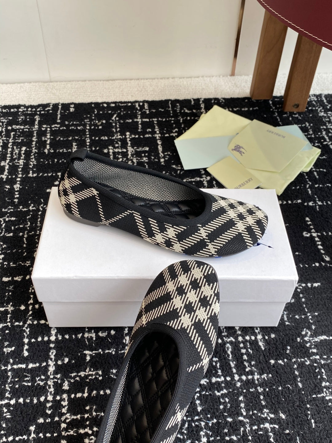 Check-print slip-on flat with black quilted toe detail and blue logo embroidery