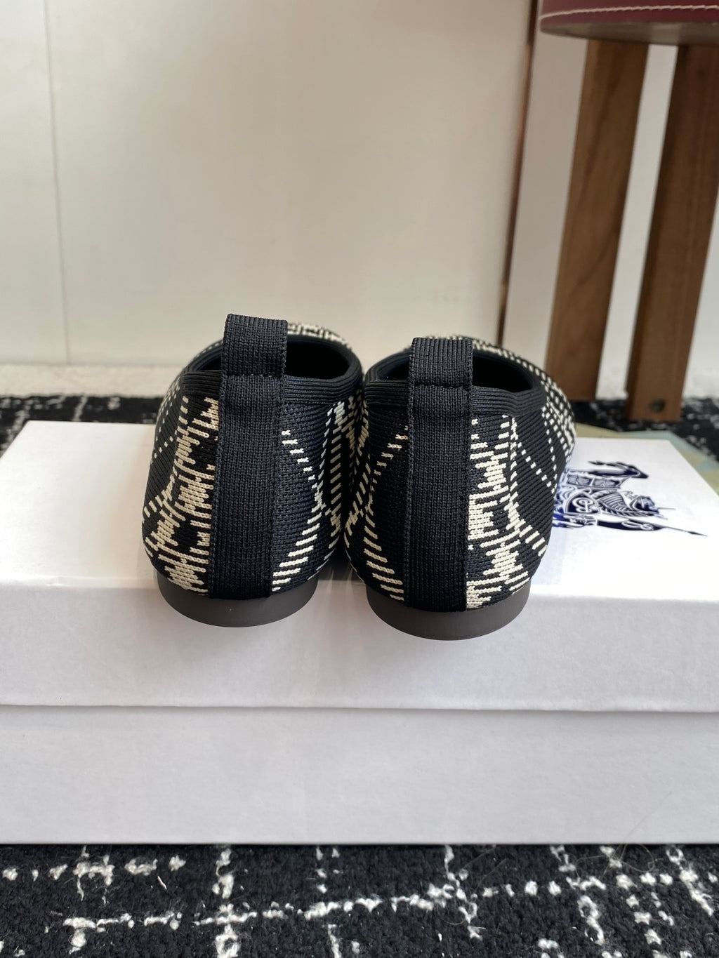 Check-print slip-on flats with black elastic heel straps and blue logo on side