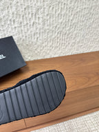 Black slide sandal rubber outsole with textured ridges