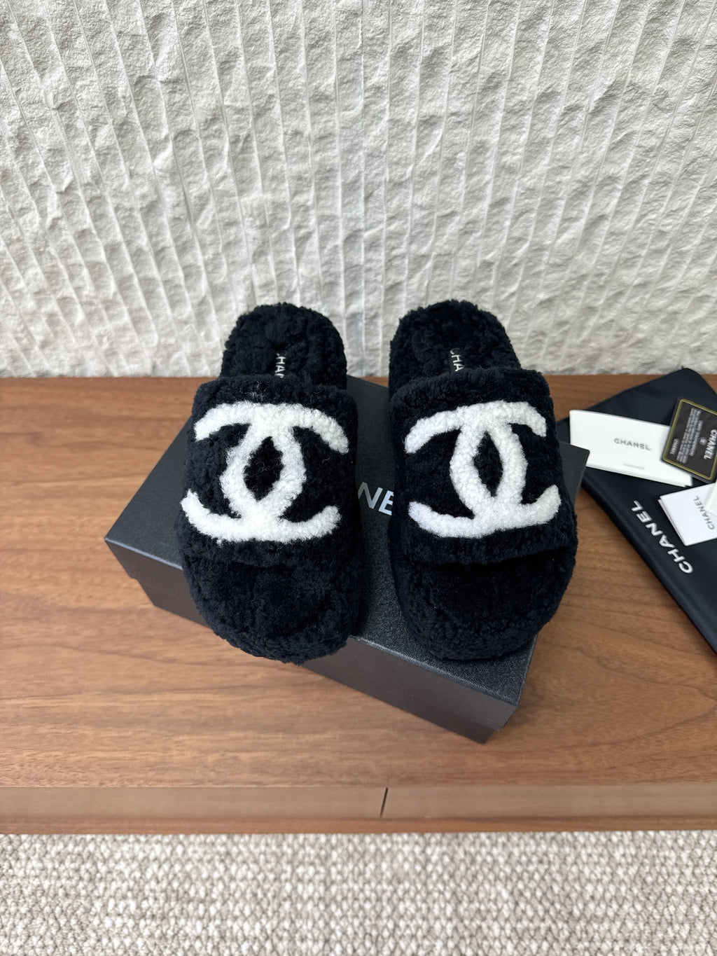 Black plush slide sandals with white double-C logo straps