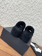 Pair of black plush slide sandals with open toe and cuff