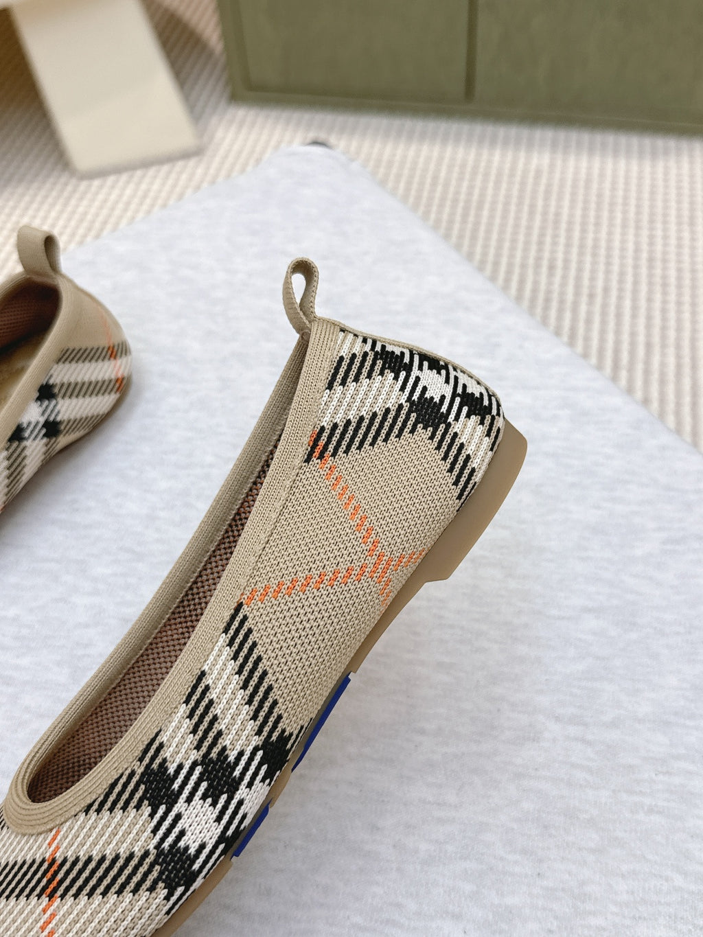 Plaid slip-on shoe side view with tan trim and heel pull tab