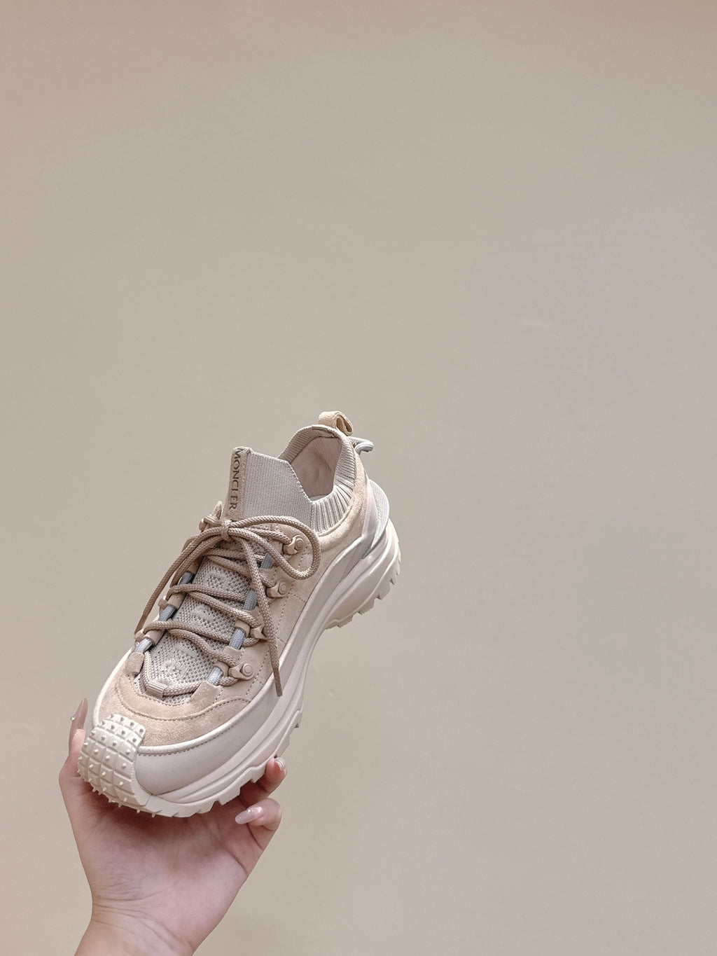 Moncler light beige sneaker held up, lace-up front and cushioned collar