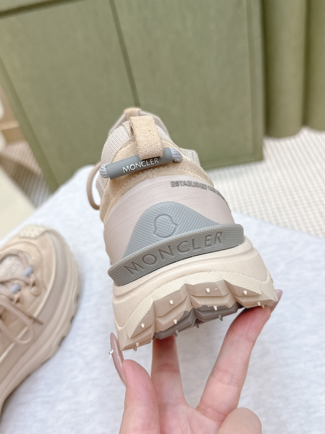 Moncler light beige sneakers heel view, logo strap and rubber tread outsole detail