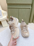 Moncler light beige sneaker held by hand, lace-up with padded collar and heel logo