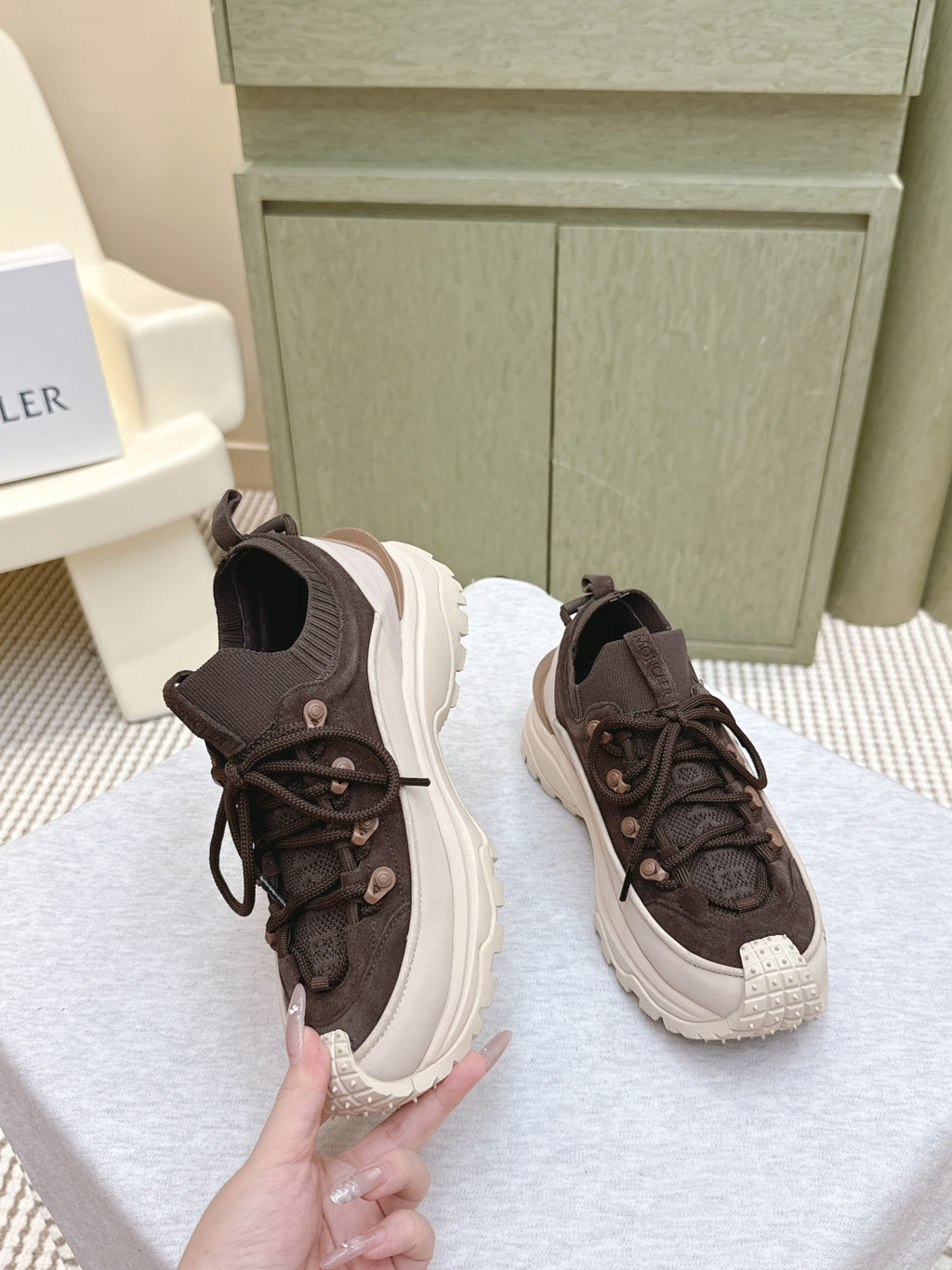 Dark brown lace-up sneakers with chunky white sole, side and toe view