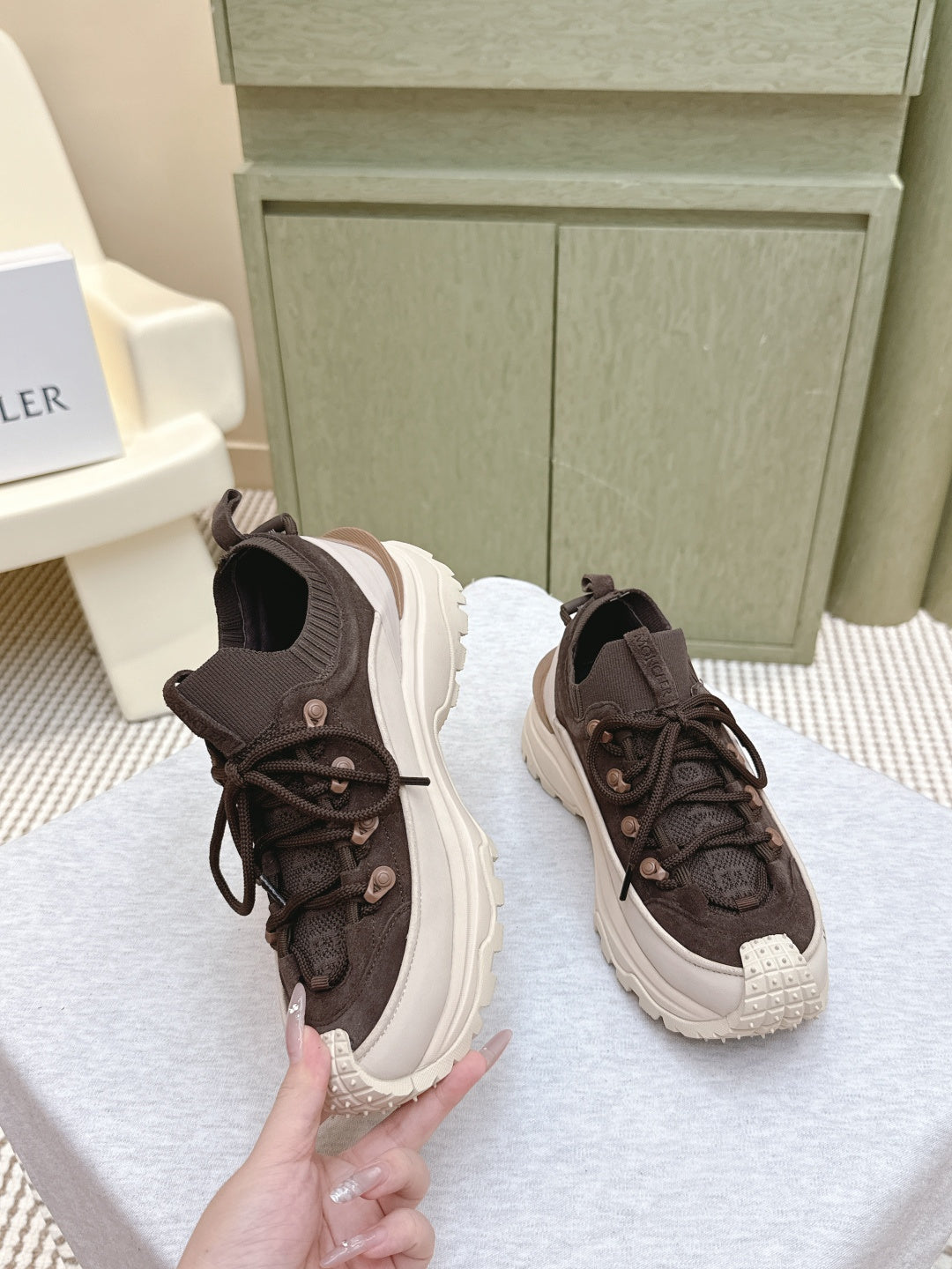 Dark brown lace-up sneakers with chunky white sole, side and toe view