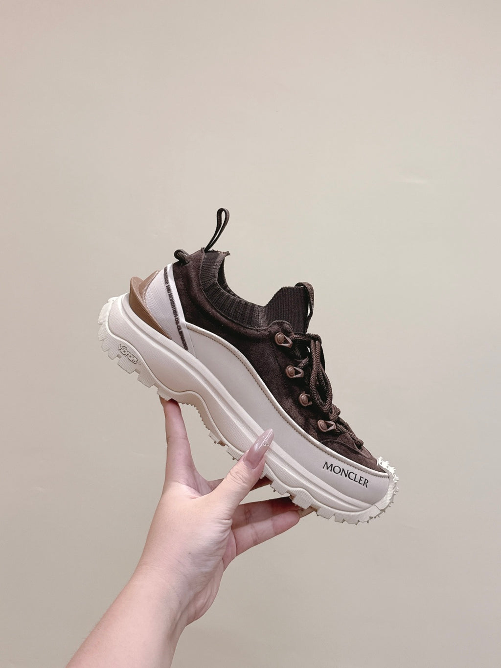 Dark brown Moncler sneakers with lace-up front, chunky white sole, side view