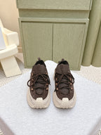 Dark brown lace-up sneakers with chunky white rubber sole, pair view