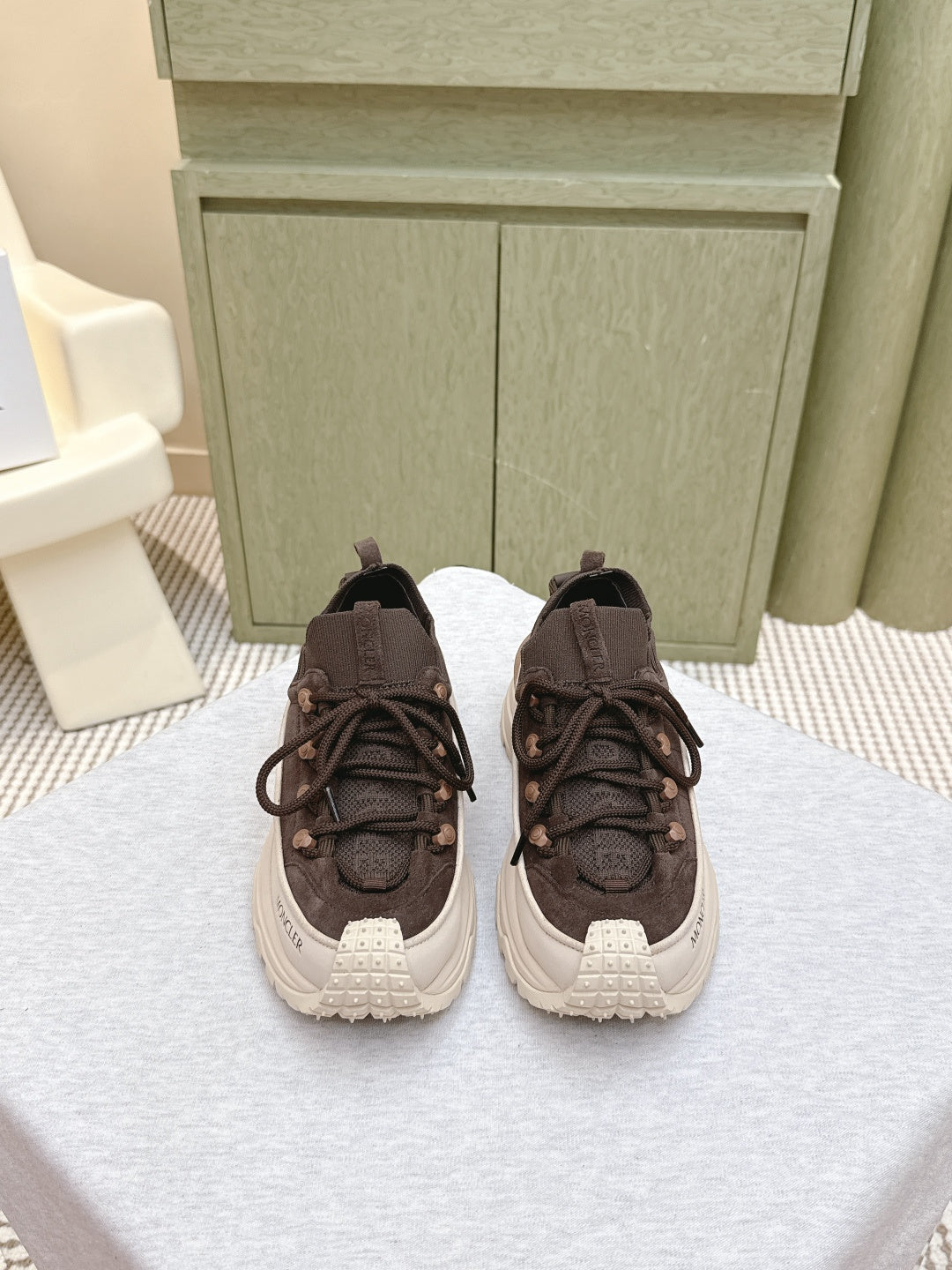 Dark brown lace-up sneakers with chunky white rubber sole, pair view