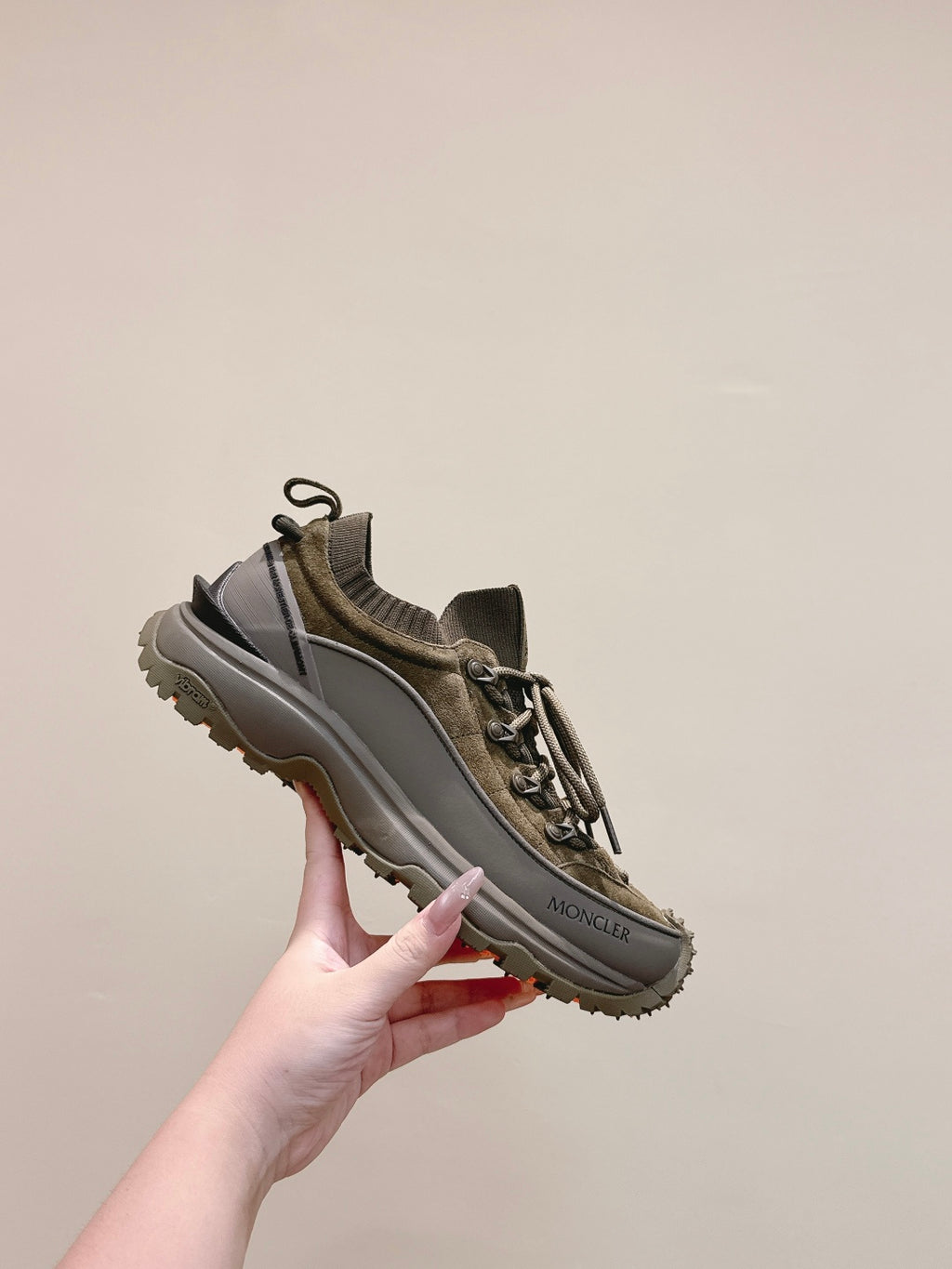Moncler olive running sneaker angled view with lace-up and side logo