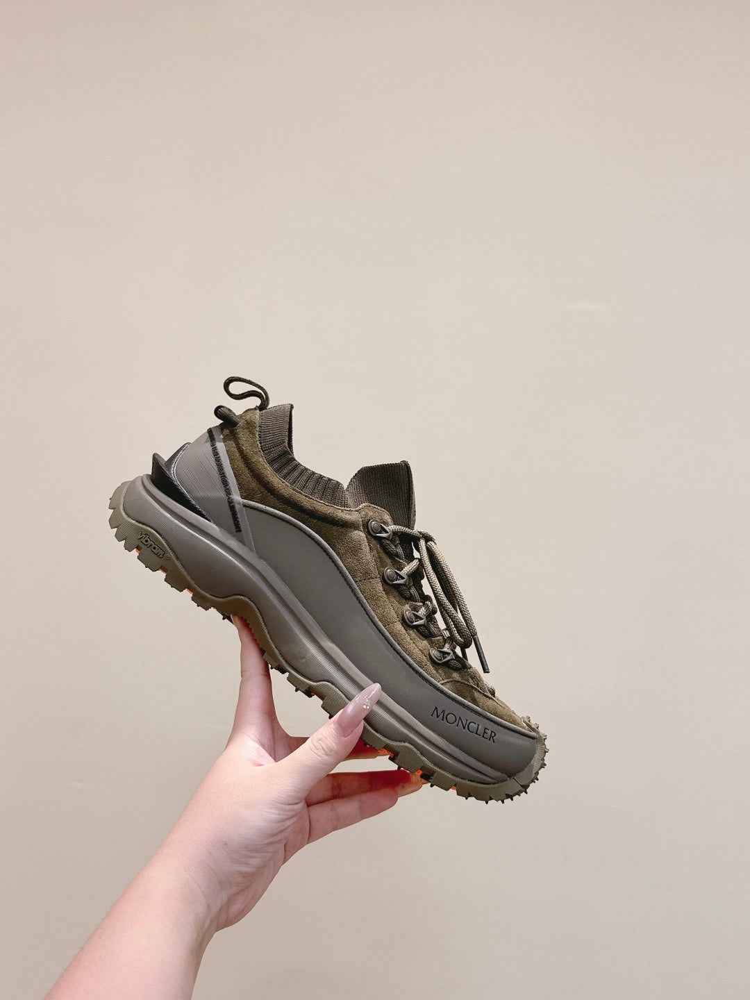 Moncler olive running sneaker angled view with lace-up and side logo