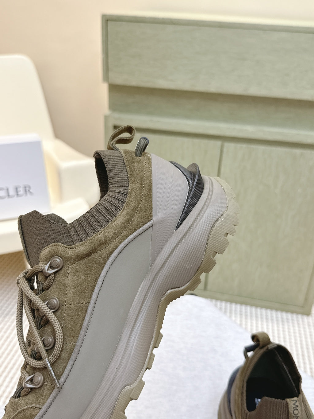 Moncler olive running sneaker side profile with lace-up and contrasting heel panel