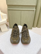 Moncler olive running sneaker with lace-up front and rubber lug sole