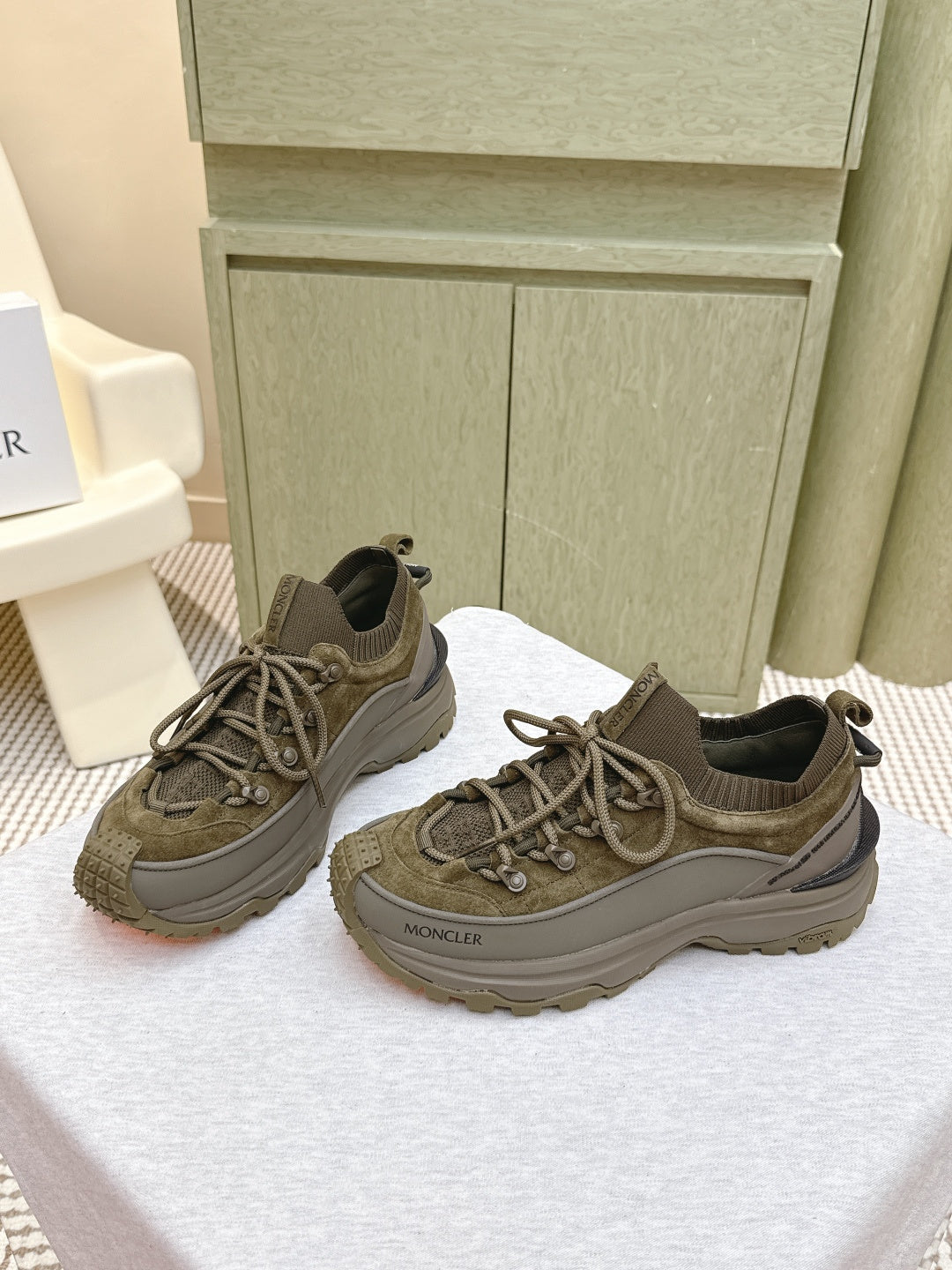 Moncler olive running sneakers showing lace-up and textured toe panel