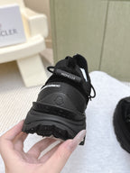 Black Moncler sneaker heel view with logo tab and rugged outsole