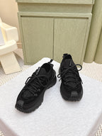 Black Moncler lace-up sneakers, pair shown from front with textured uppers