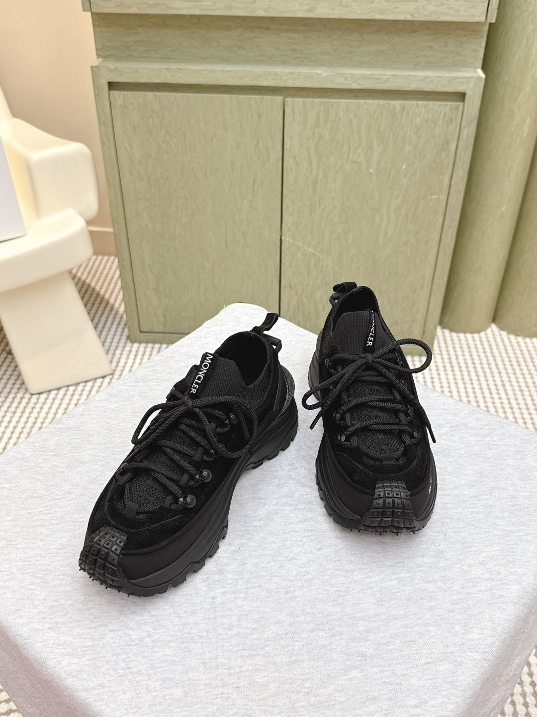 Black Moncler lace-up sneakers, pair shown from front with textured uppers