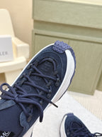 Navy sneaker upper with black laces and textured toe panel, close-up