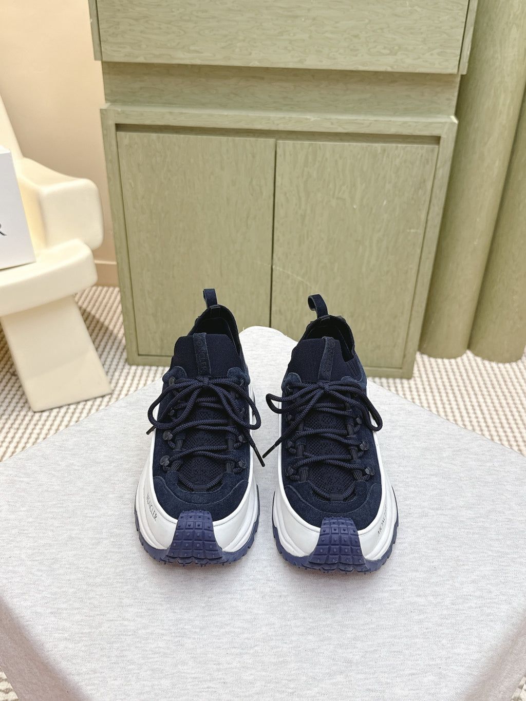 Navy sneakers with white midsoles and black laces, side-by-side view