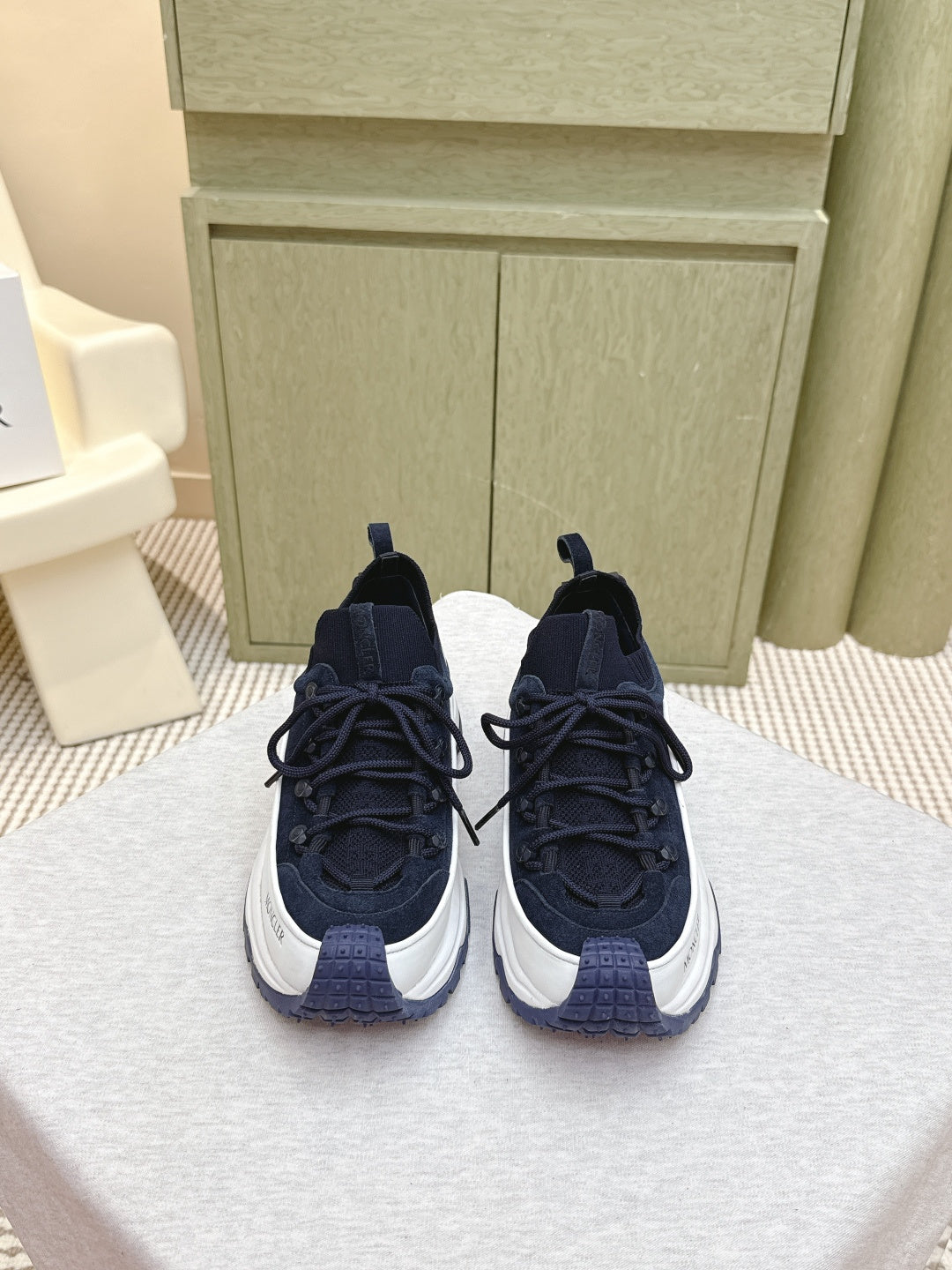 Navy sneakers with white midsoles and black laces, side-by-side view