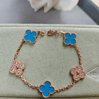 Rose gold bracelet with blue clover links and small flower charms, adjustable clasp