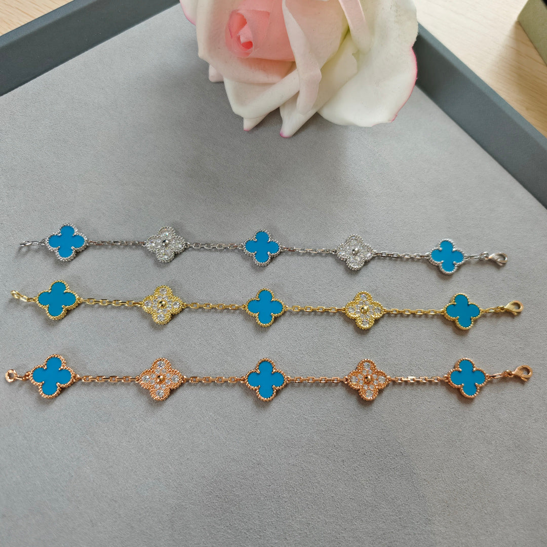 Clover charm bracelets with blue enamel and sparkling flower links in silver, gold, rose gold