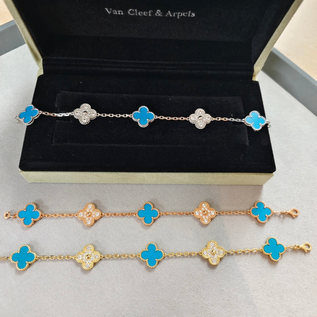 Clover charm bracelets with blue enamel and sparkling flower accents in a gift box