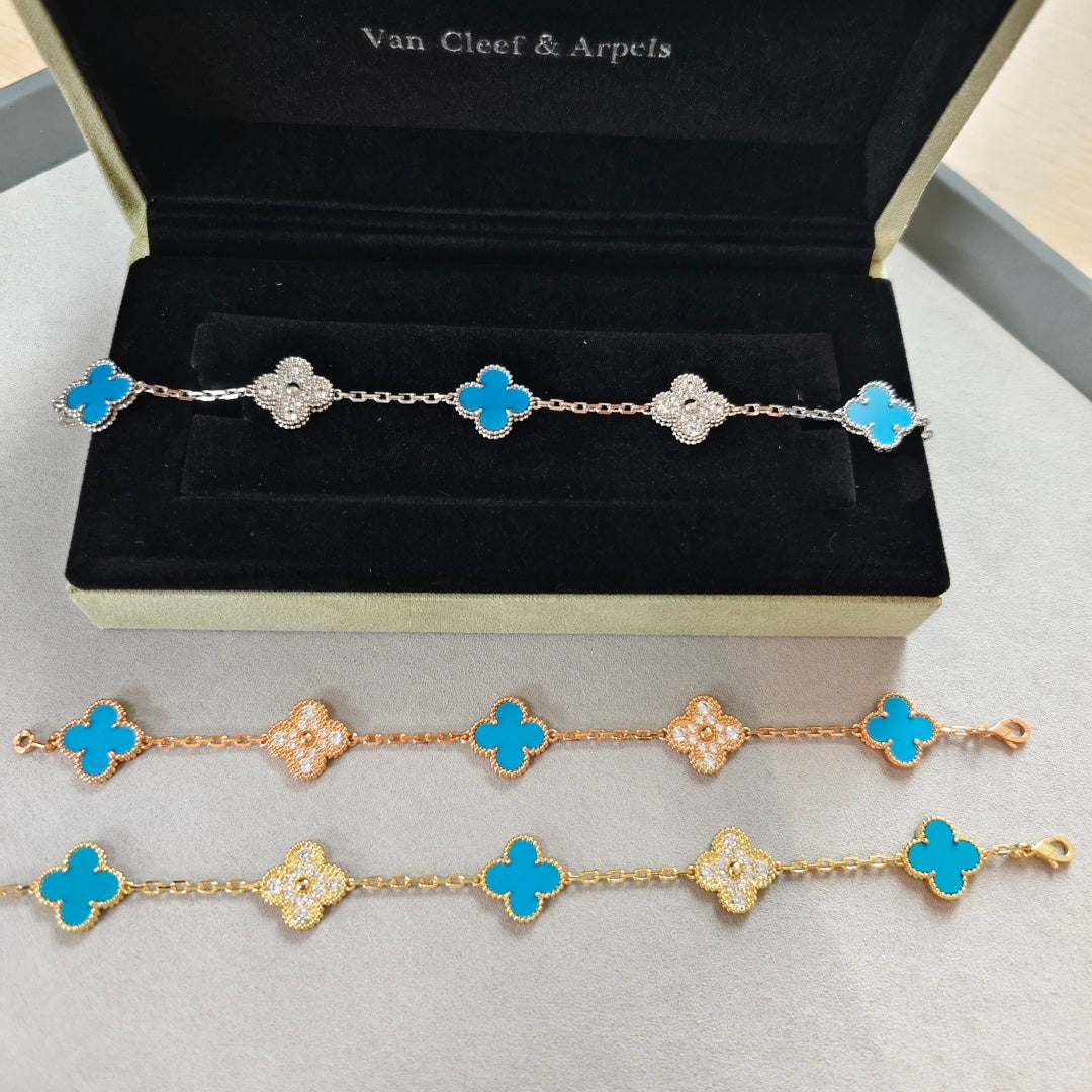 Clover charm bracelets with blue enamel and sparkling flower accents in a gift box