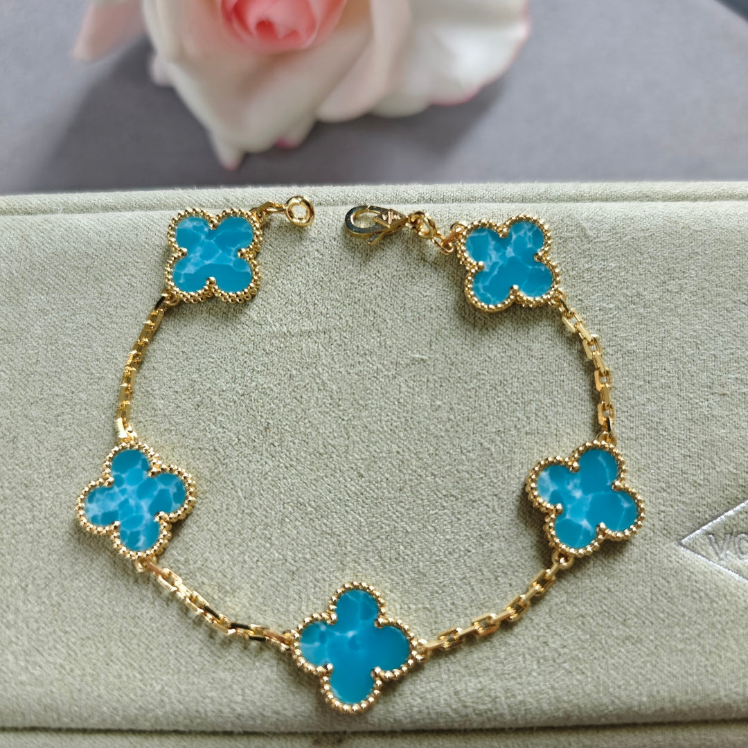 Van Cleef & Arpels clover charm bracelet, blue enamel on gold-tone chain