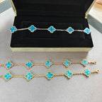 Van Cleef & Arpels clover charm bracelets on display, gold and silver tones, blue enamel