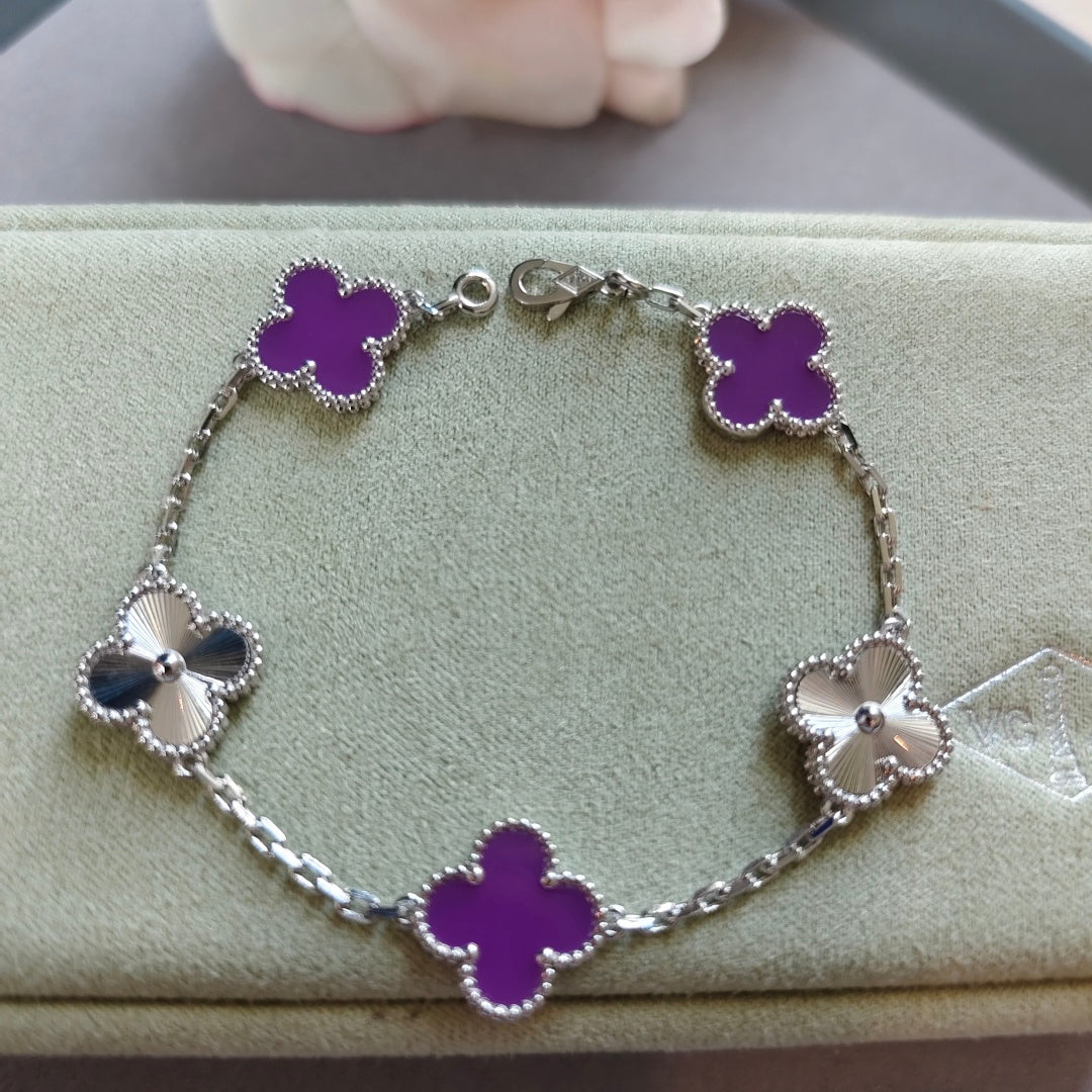 Van Cleef & Arpels clover charm bracelet, silver chain with purple enamel clovers and bow charms