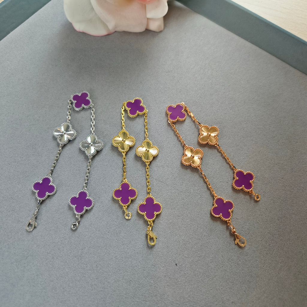 Van Cleef & Arpels clover charm bracelets, silver, gold, and rose gold with purple enamel clovers